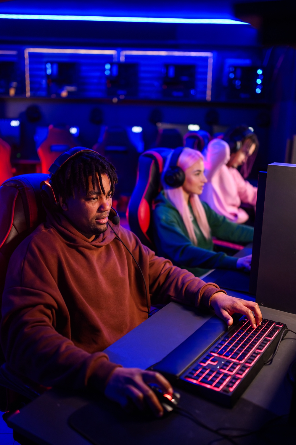 Focused female cybersport gamer wearing headphones.